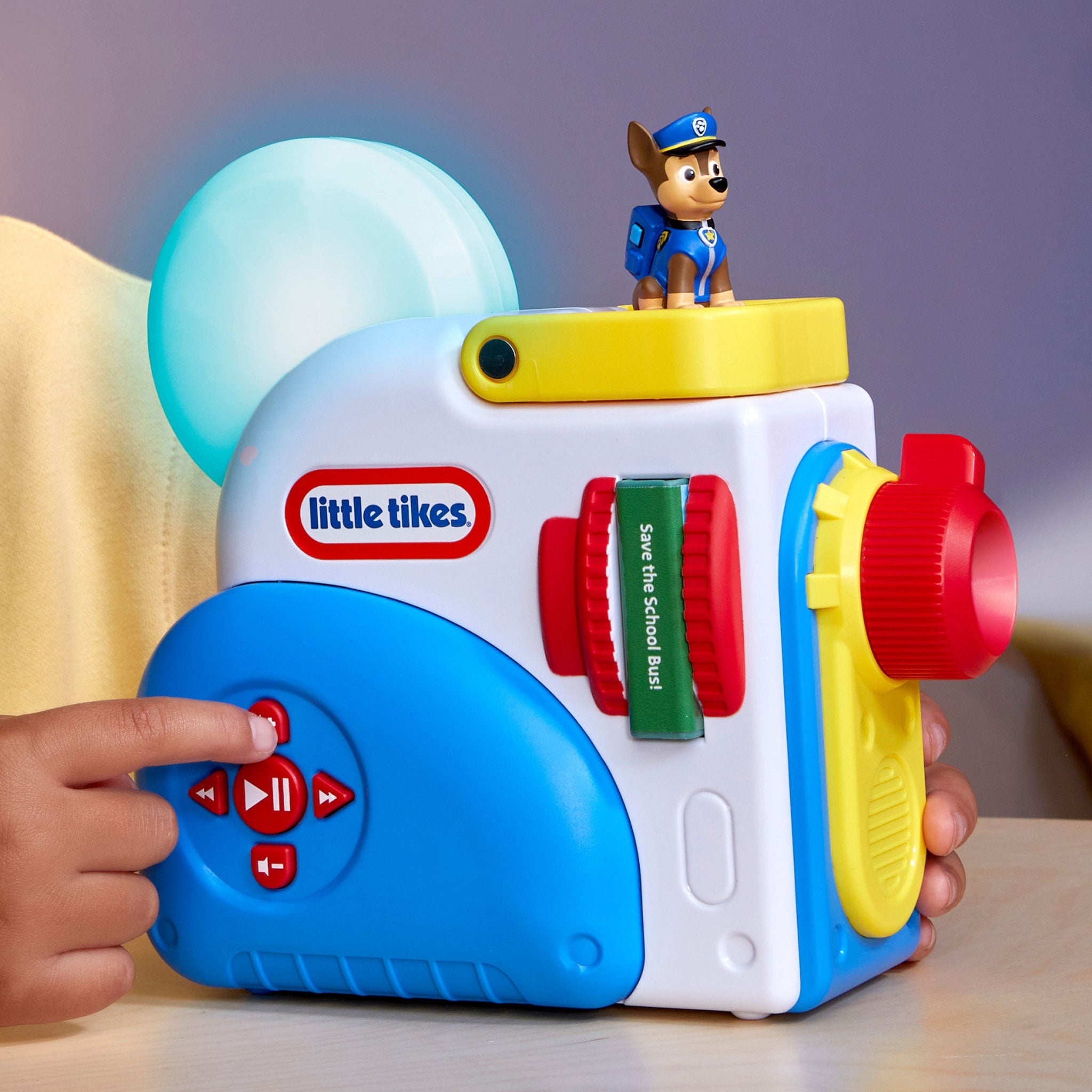 Story Dream Machine with a character on top, featuring the Little Tikes logo, held by a child.