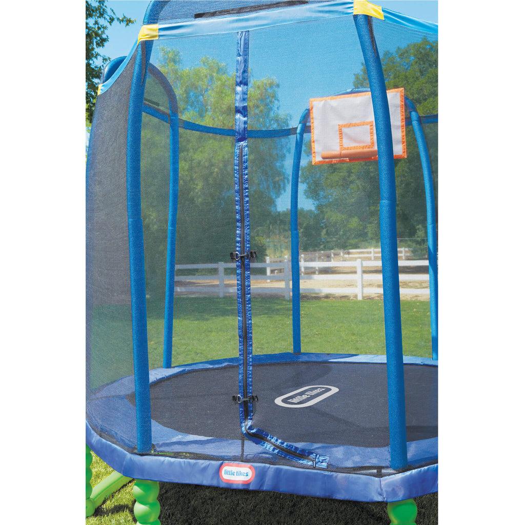 Blue trampoline with safety net and basketball hoop in a backyard setting