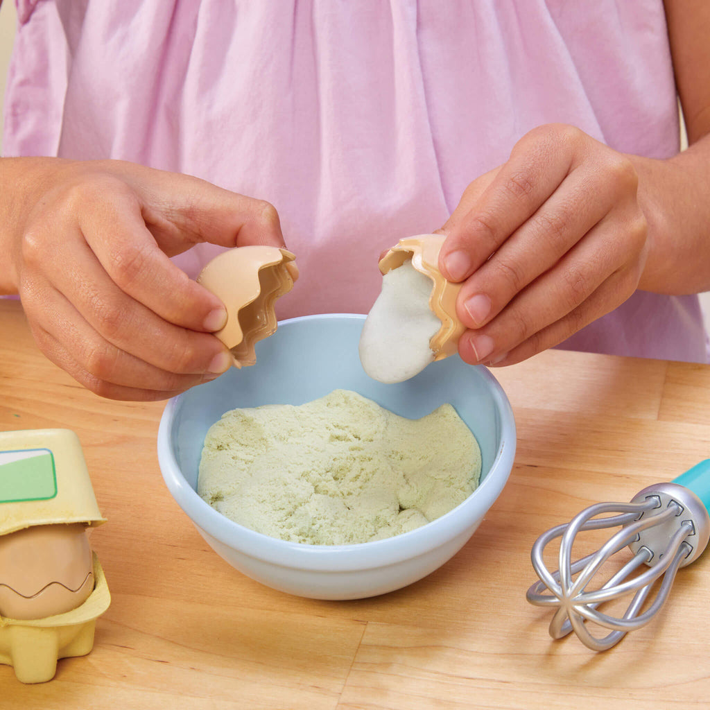 Girl "breaking" a pretend egg